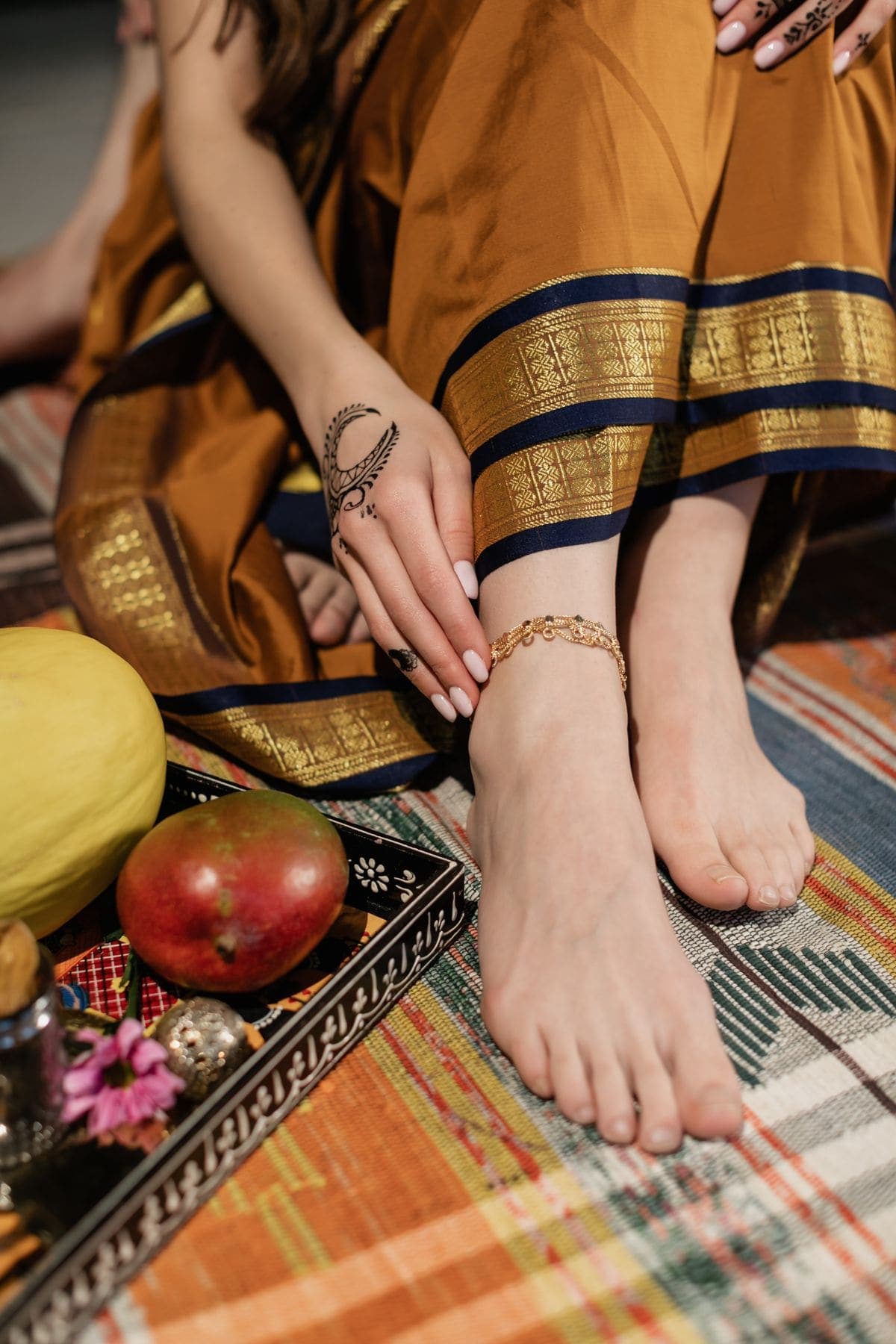 Gold-tone anklet worn with a sari