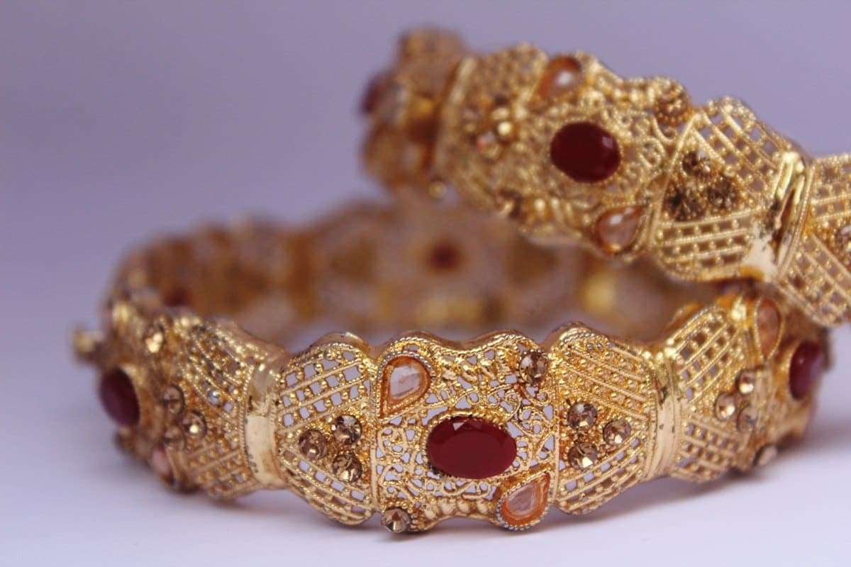 Ornate gold-tone bridal bangles with red stones