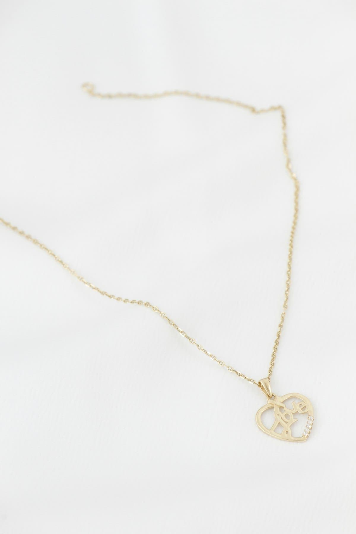 Gold-tone heart pendant on a fine chain